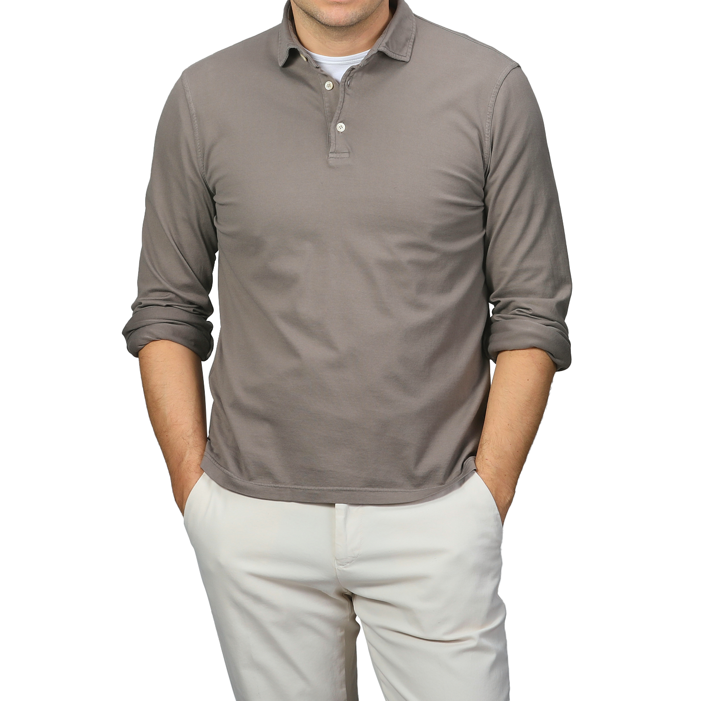 A person in a Fedeli Taupe Beige Organic Cotton LS Polo Shirt and light pants stands with hands in pockets, exuding effortless elegance.