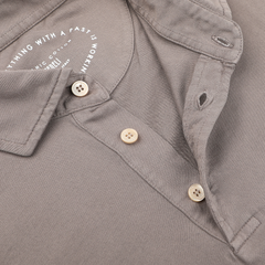 Close-up of the Taupe Beige Organic Cotton LS Polo Shirt by Fedeli, featuring rich Giza cotton and three cream-colored buttons, with printed text inside the collar, exuding luxury casual-wear.