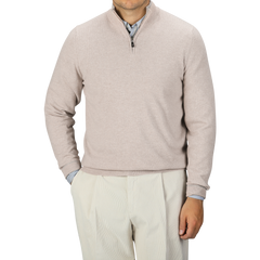 A person is wearing the Fedeli Taupe Beige Wool Cashmere 1/4 Zip Sweater over a blue collared shirt and light-colored trousers. They stand against a plain background, with their face not visible in the image.