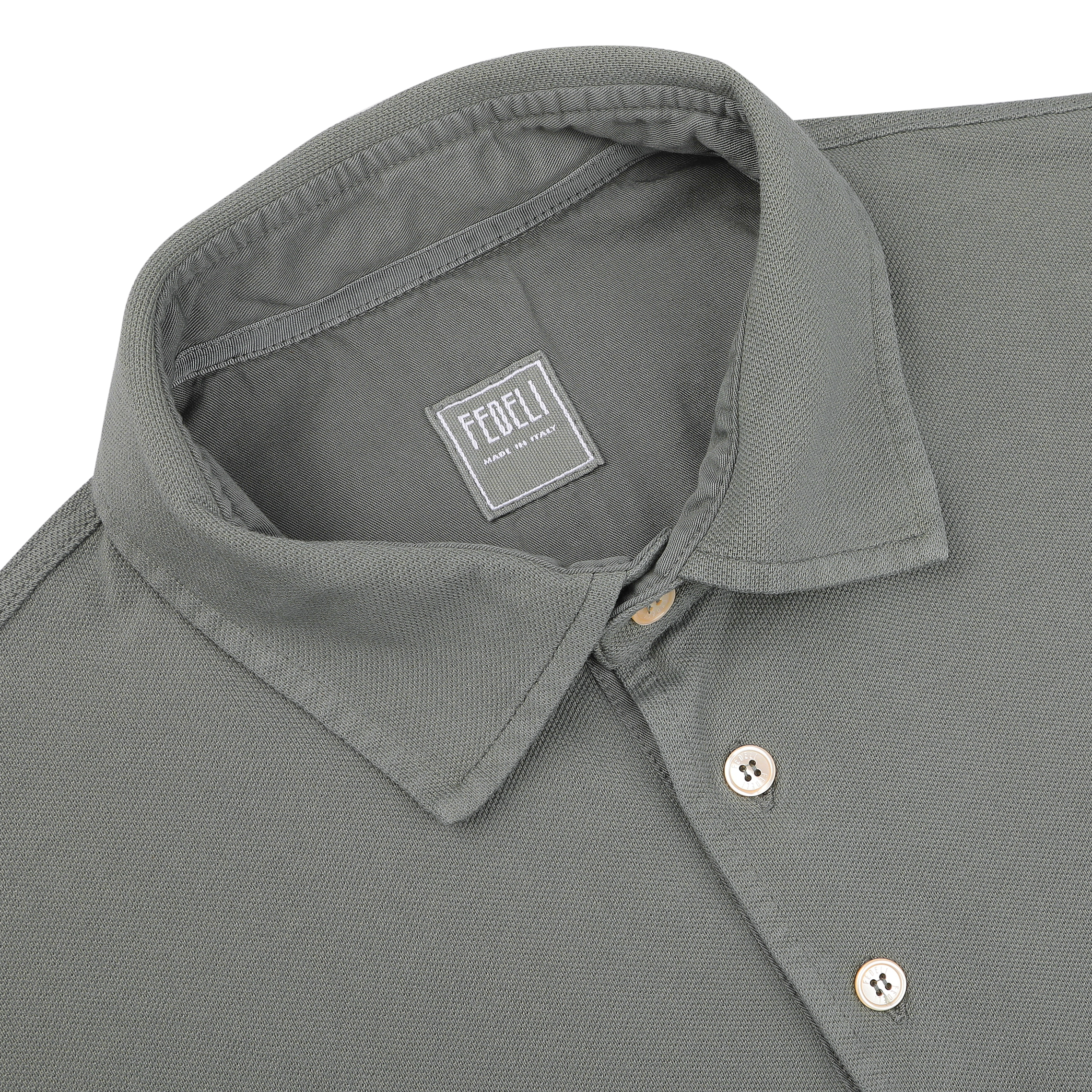 This Washed Green Cotton Pique Polo Shirt exudes superior quality with its collar design. The label "Fedeli Made in Italy" assures timeless craftsmanship and style.