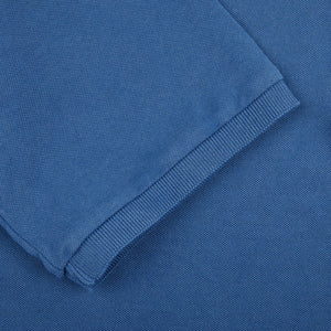 A close up of a Fedeli Washed Light Blue Cotton Pique Polo Shirt.