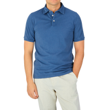 A man wearing a Fedeli Washed Light Blue Cotton Pique Polo Shirt.