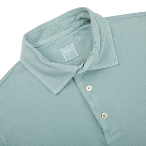 A close up of a Fedeli washed light green cotton pique polo shirt.