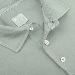 A close-up of a washed light green cotton pique polo shirt highlights its superior quality with three visible buttons. The "Fedeli" tag inside confirms it's a must-have for any summer wardrobe.