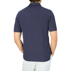 The back view of a man wearing a Fedeli Washed Navy Cotton Pique Polo Shirt.