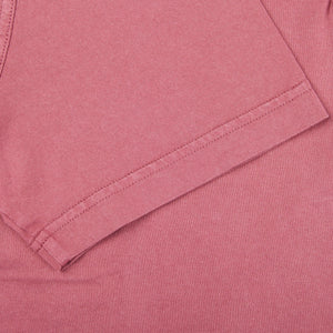 A close up of a Fedeli Washed Raspberry Organic Cotton Polo Shirt.