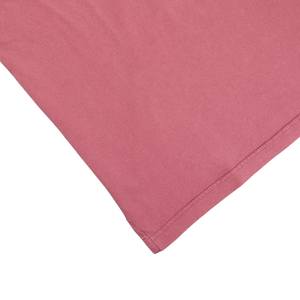 A Fedeli Washed Raspberry Organic Cotton Polo Shirt on a white surface.