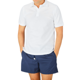 A man wearing a Fedeli washed white cotton pique polo shirt.