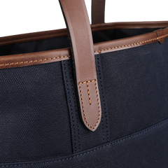 Close-up of the Felisi Navy Blue Cotton Canvas Leather Tote Bag, showcasing its rich vacchetta calf leather handles and stitching details.