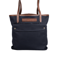 Introducing the Felisi Navy Blue Cotton Canvas Leather Tote Bag, which boasts vacchetta calf leather straps and accents.