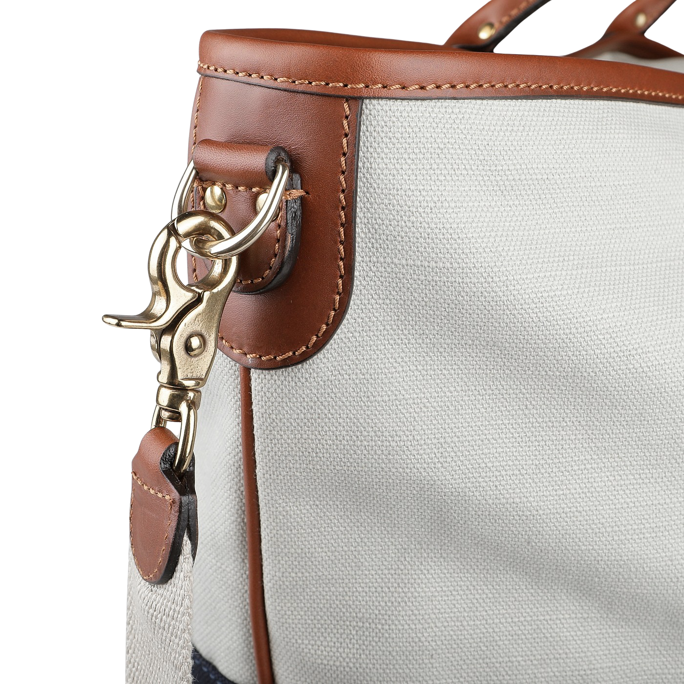 Close-up of the Felisi Navy Grey Cotton Canvas Leather Travel Tote, showcasing vacchetta calf leather trim and a gold-toned metal clip attached to the strap.