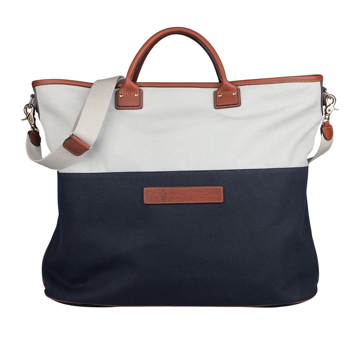 The Felisi Navy Grey Cotton Canvas Leather Travel Tote is crafted from durable cotton canvas, featuring brown vacchetta calf leather handles and a beige shoulder strap. It showcases a white upper section and a navy lower section, highlighted by a rectangular leather patch in the center.