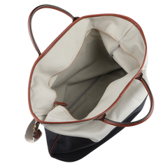 The Navy Grey Cotton Canvas Leather Travel Tote by Felisi is a roomy accessory crafted from robust cotton canvas, complemented by luxurious vacchetta calf leather handles and trim. Its bright interior is perfect for accommodating all your essentials.