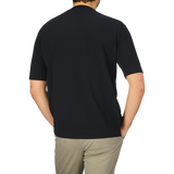 A man in a Filippo de Laurentiis Black Crepe Cotton Oversized T-Shirt.