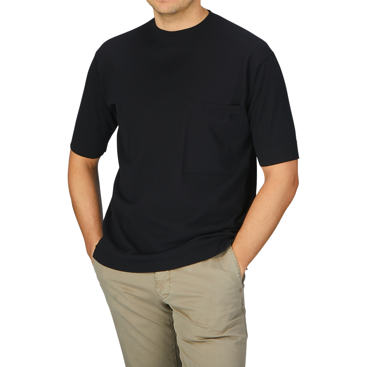 A man wearing a Filippo de Laurentiis Black Crepe Cotton Oversized T-Shirt and khaki pants.