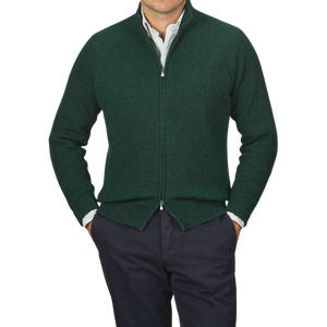 A person wearing a Bottle Green Cashmere Rib Knit Cardigan by Filippo de Laurentiis over a striped shirt with navy pants, standing against a plain background.