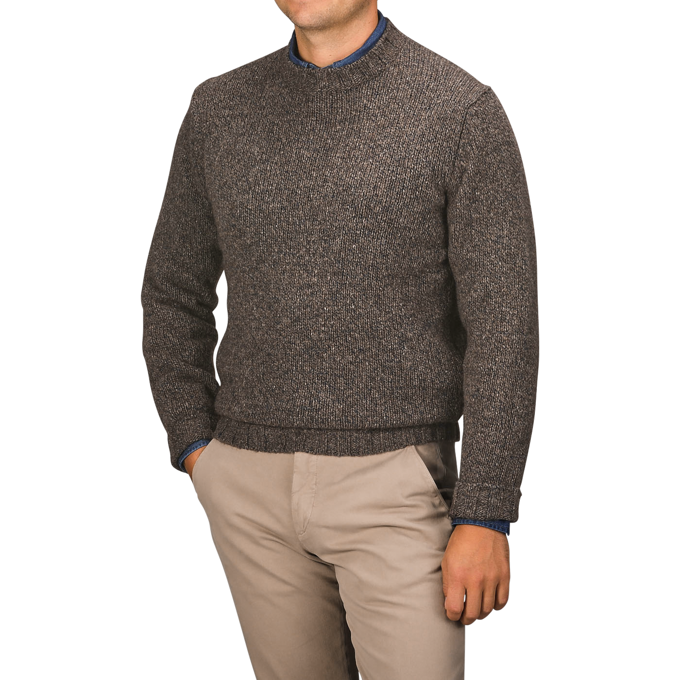 A person wearing a Filippo de Laurentiis Brown Melange Yak Cashmere Sweater—a seasonal staple—over a blue shirt and beige pants stands against a neutral background with hands in pockets.