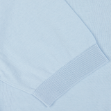 Light blue crepe cotton Filippo de Laurentiis polo shirt with a close-up on a finely ribbed cuff.