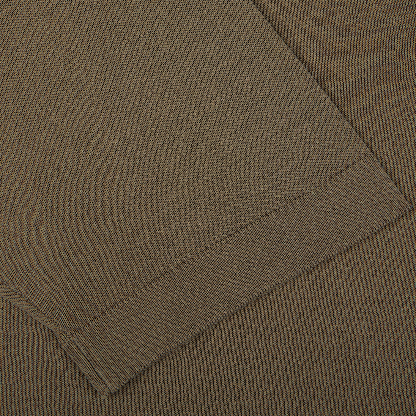 Close-up of a folded Mole Grey Crepe Cotton Polo Shirt made by Filippo de Laurentiis, showcasing its texture and ribbed hem.