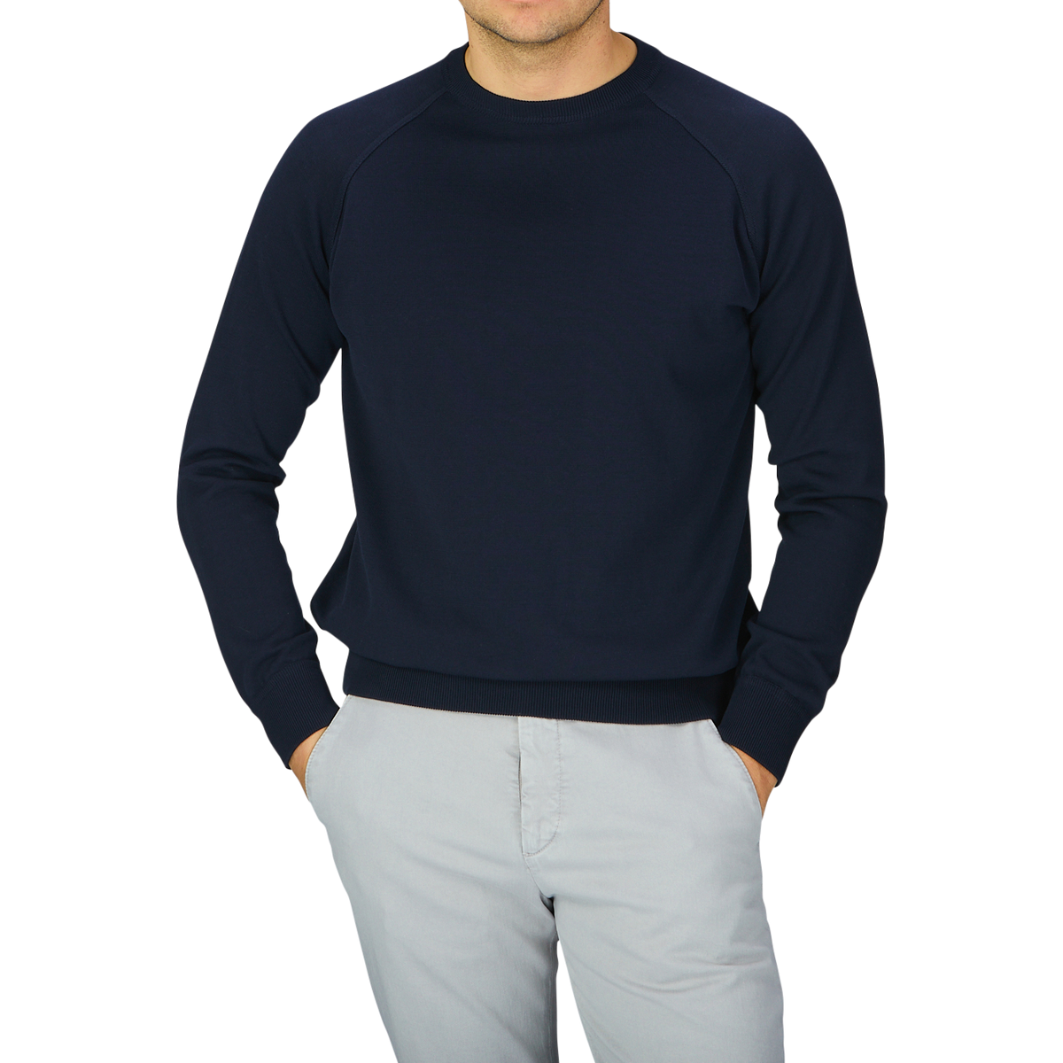 A man wearing a Filippo de Laurentiis navy blue crepe cotton crew neck sweater and grey pants.