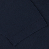 Close-up of a Filippo de Laurentiis navy blue crepe cotton polo shirt, focusing on the detailed weave and hem.