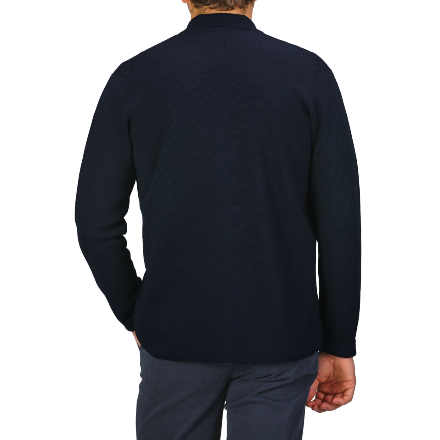 A person wearing a long-sleeve, dark navy shirt and gray pants stands with their back to the camera, complemented by the stylish Navy Blue Extrafine Merino Field Jacket from Filippo De Laurentiis.