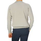 The back view of a man wearing a Filippo de Laurentiis Nebbia Grey Crepe Cotton Crew Neck Sweater.