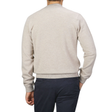 A person is shown from behind, wearing a Filippo de Laurentiis Taupe Beige Wool Cashmere Knitted Bomber and dark pants against a gray background.