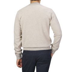 A person is shown from behind, wearing a Filippo de Laurentiis Taupe Beige Wool Cashmere Knitted Bomber and dark pants against a gray background.