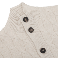 Close-up of the Filippo de Laurentiis Cream Wool Cashmere Cableknit Button Cardigan, showcasing a delicate beige pattern and three dark brown buttons.