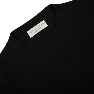 A black crepe cotton oversized t-shirt with a white label by Filippo de Laurentiis.