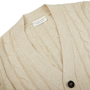 A close-up of a Filippo de Laurentiis Ecru Extrafine Merino Wool Cable Knit Cardigan in signature style.
