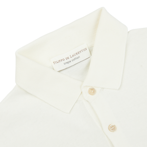 A close up of a white Filippo de Laurentiis Latte White Crepe Cotton Polo Shirt.