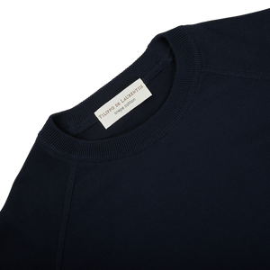 The back of a Filippo de Laurentiis navy blue crepe cotton crew neck sweater with a label on it.