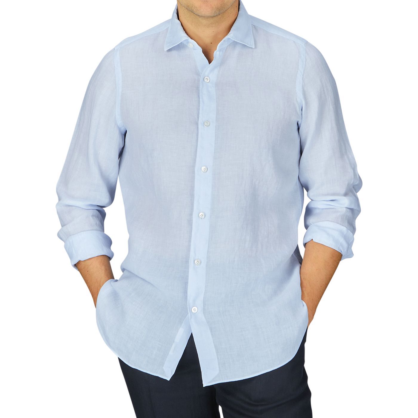 Man in a Finamore Light Blue Linen Casual Shirt and dark trousers standing with arms at his sides against a grey background.