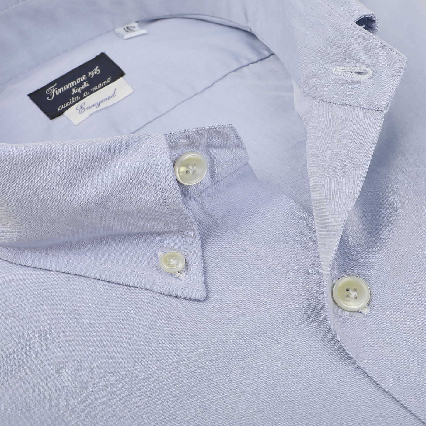 Close-up of the Light Blue Washed Cotton BD Shirt by Finamore, featuring a slim-fit design with buttons fastened and a label on the collar.