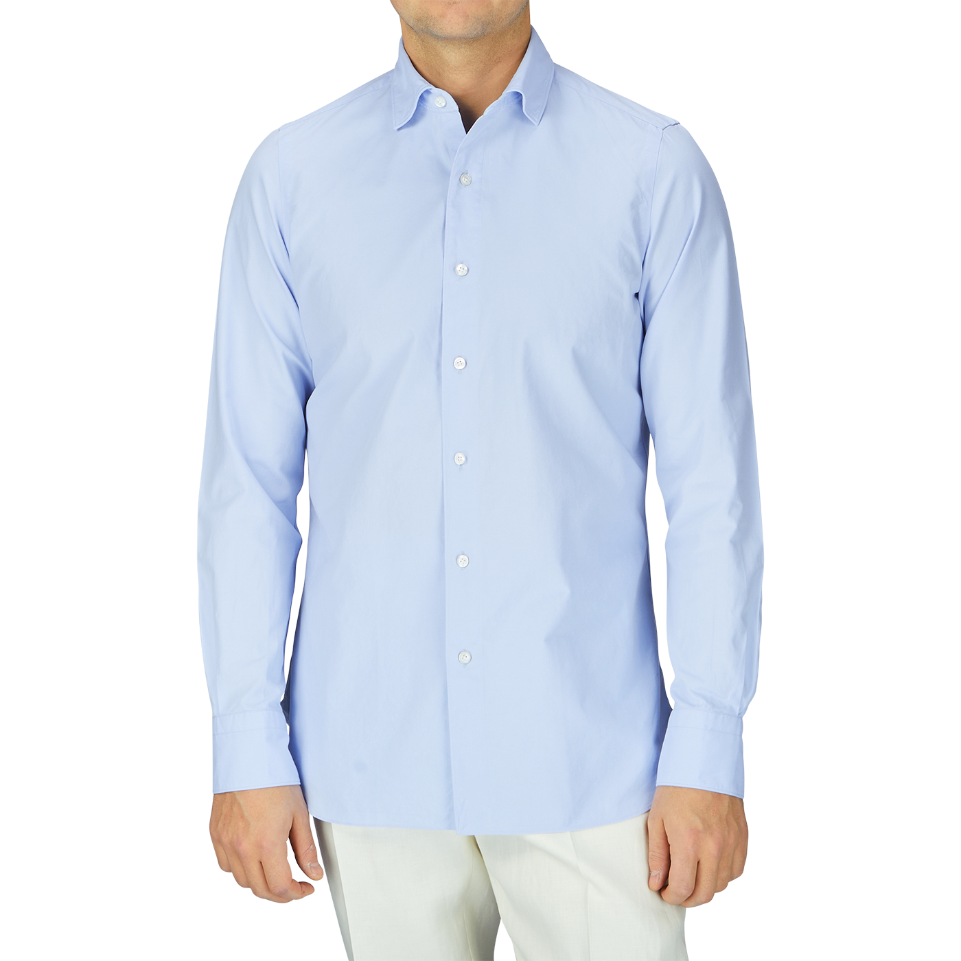 A man in a Finamore Light Blue Washed Cotton Twill Shirt and white pants.