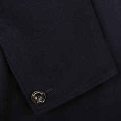 Close-up of the Navy Blue Boiled Wool Casual Blazer by Finamore, showcasing its dark boiled wool fabric with a folded edge and adorned with a metallic button featuring an engraved logo, ideal for that casual blazer look.