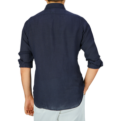 Man from behind wearing a Finamore Navy Blue Linen Casual Shirt with rolled-up cuffs.