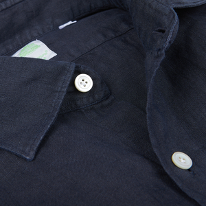 Close-up view of a dark, handmade Navy Blue Linen Casual Shirt with visible collar and tag by Finamore.