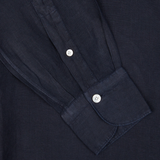 Close-up view of a Finamore navy blue linen casual shirt cuff with two white buttons.