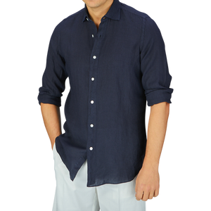 A person wearing a Finamore Navy Blue Linen Casual Shirt and white pants against a gray background.