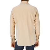A man in a Sand Beige Washed Cotton Twill shirt, likely a Finamore handmade shirt, seen from behind.