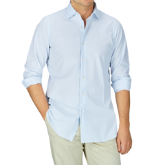 A man dressed in a Sky Blue Striped Cotton Seersucker Shirt and khaki pants by Finamore.