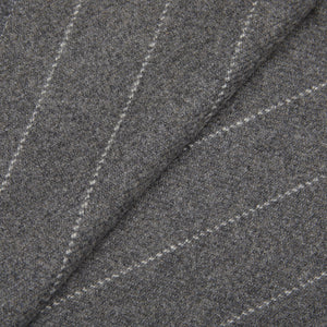 A close up of a Grey Chalkstripe Merino Wool Cashmere Scarf by Fox Brothers, featuring fringed endings.
