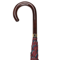 A handmade Fox Umbrellas creation, the Red Blue Striped Maple Handle Umbrella features a wooden crook handle and a burgundy and blue checkered fabric, rolled and closed.