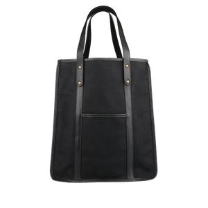 The Frank Clegg Black Canvas Tumbled Leather Market Tote Bag features durable handles, a convenient front pocket, and elegant leather trimmings, all crafted from premium black cotton canvas.