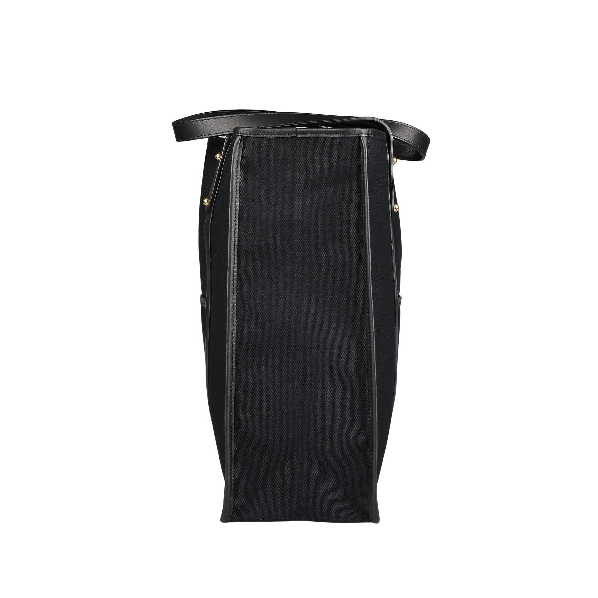 Side view of the Frank Clegg Black Canvas Tumbled Leather Market Tote Bag featuring leather handles, trimmings, and sleek metal rivets.