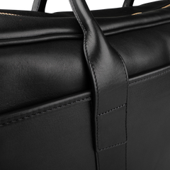 Close-up of the Frank Clegg Black Tumbled Leather Commuter Briefcase, crafted with visible stitching and a sturdy handle.