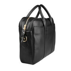 The Frank Clegg Black Tumbled Leather Commuter Briefcase, elegantly crafted with a gold zipper and dual handles, accommodates a 15″ laptop. It stands sleekly against a white background with effortless elegance.